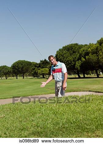 Man playing golf, stuck in bunker View Large Photo Image Stock Photo - Man playing golf, stuck in bunker. Fotosearch