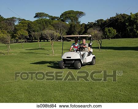 Picture - Two mature men in golf cart on golf course. Fotosearch