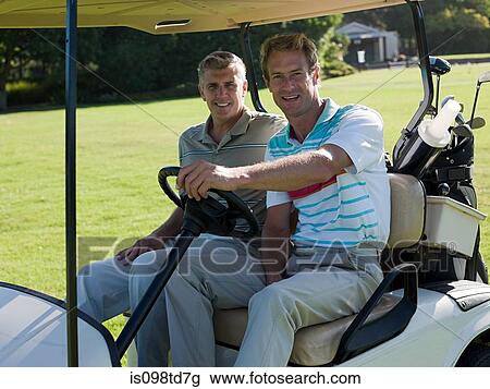 Two mature men in golf cart on golf course View Large Photo Image Stock Image - Two mature men in golf cart on golf course. Fotosearch