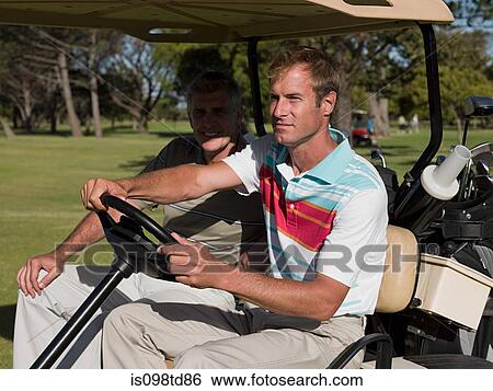 Two mature men in golf cart on golf course View Large Photo Image Stock Photograph - Two mature men in golf cart on golf course. Fotosearch