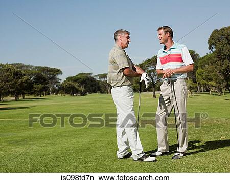 Two mature men playing golf together View Large Photo Image Picture - Two mature men playing golf together. Fotosearch