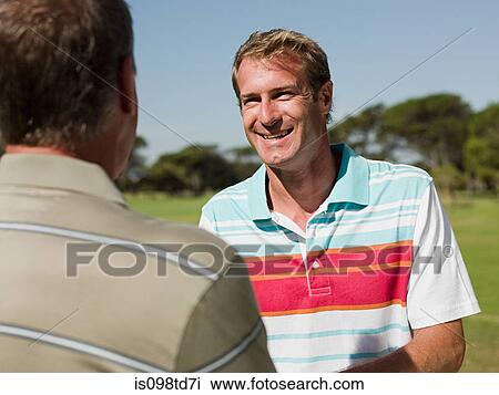Two mature men playing golf together View Large Photo Image Stock Image - Two mature men playing golf together. Fotosearch