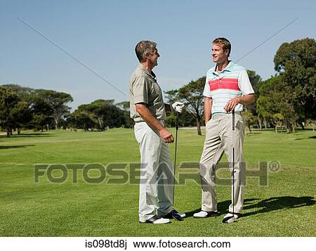 Two mature men playing golf together View Large Photo Image Stock Image - Two mature men playing golf together. Fotosearch