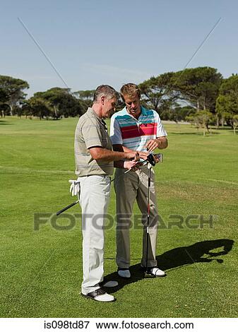 Two mature men playing golf together View Large Photo Image Stock Photo - Two mature men playing golf together. Fotosearch