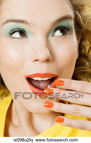Surprised young blonde woman against yellow background View Large Photo Image Stock Photography - Surprised young blonde woman against yellow background. Fotosearch
