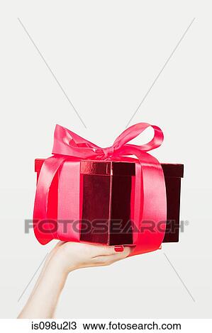Young woman offering present View Large Photo Image Stock Image - Young woman offering present. Fotosearch