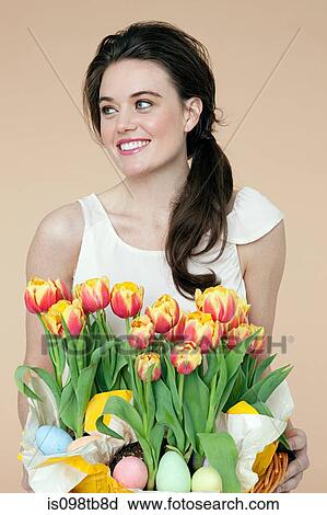 Woman with basket of flowers and easter eggs View Large Photo Image Stock Image - Woman with basket of flowers and easter eggs. Fotosearch