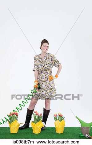 Woman with hose and flowers on artificial turf View Large Photo Image Picture - Woman with hose and flowers on artificial turf. Fotosearch