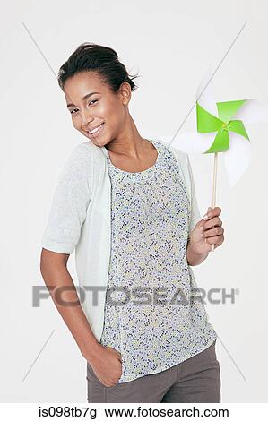 Young woman with a pinwheel View Large Photo Image Stock Image - Young woman with a pinwheel. Fotosearch
