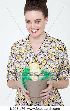 Young woman with easter chick and eggs in flower pot View Large Photo Image Stock Photograph - Young woman with easter chick and eggs in flower pot. Fotosearch