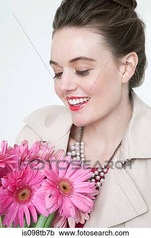 Young woman with gerbera flowers View Large Photo Image Stock Image - Young woman with gerbera flowers. Fotosearch