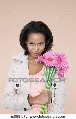 Young woman with pink flowers View Large Photo Image Stock Photo - Young woman with pink flowers. Fotosearch