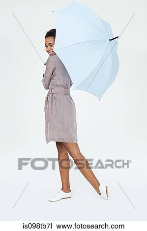 Young woman with umbrella View Large Photo Image Stock Image - Young woman with umbrella. Fotosearch
