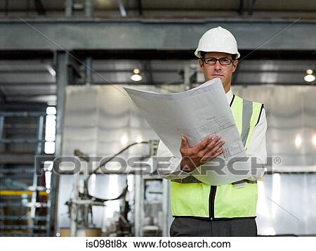 Mature man with blueprint in factory View Large Photo Image Stock Photo - Mature man with blueprint in factory. Fotosearch