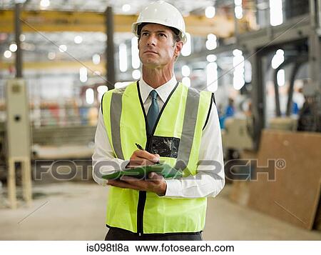 Mature man with clipboard in factory View Large Photo Image Stock Image - Mature man with clipboard in factory. Fotosearch