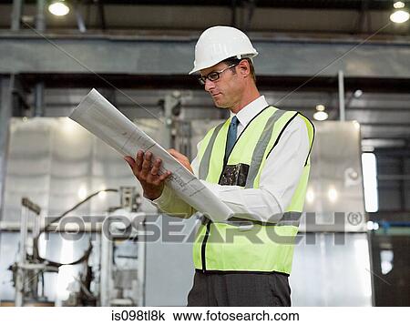 Mature man with clipboard in factory View Large Photo Image Stock Image - Mature man with clipboard in factory. Fotosearch