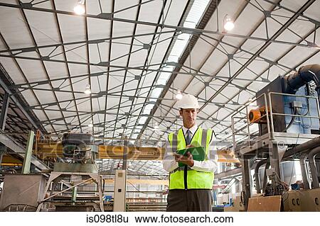 Mature man with clipboard in factory View Large Photo Image Stock Photograph - Mature man with clipboard in factory. Fotosearch