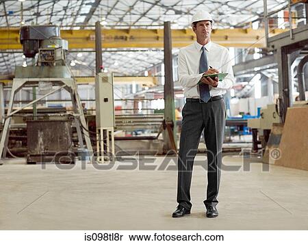 Mature man with clipboard in factory View Large Photo Image Stock Photography - Mature man with clipboard in factory. Fotosearch
