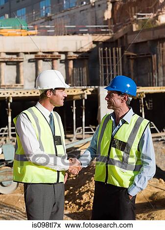 Stock Photo - Mature men meeting on construction site. Fotosearch