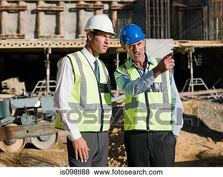 Mature men meeting on construction site View Large Photo Image Stock Photo - Mature men meeting on construction site. Fotosearch