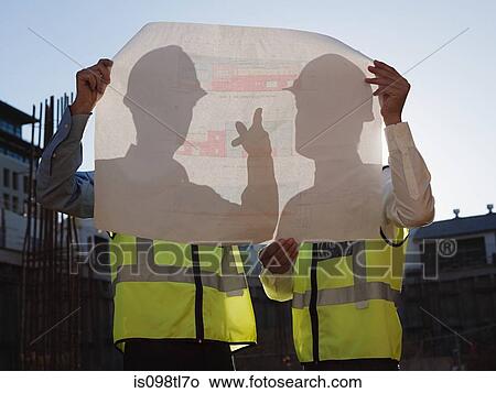 Mature men with blueprint on construction site View Large Photo Image Picture - Mature men with blueprint on construction site. Fotosearch