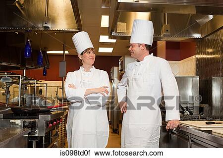 Stock Image - Chefs in commercial kitchen, portrait. Fotosearch