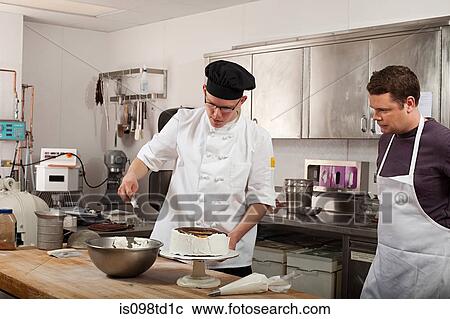 Chefs preparing food in commercial kitchen View Large Photo Image Stock Image - Chefs preparing food in commercial kitchen. Fotosearch