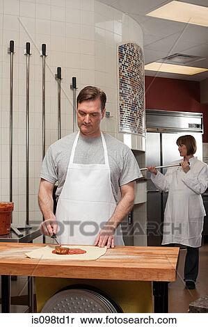 Chefs preparing food in commercial kitchen View Large Photo Image Stock Photography - Chefs preparing food in commercial kitchen. Fotosearch