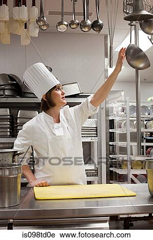 Female chef working in commercial kitchen View Large Photo Image Stock Image - Female chef working in commercial kitchen. Fotosearch