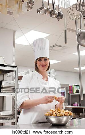 Female chef working in commercial kitchen View Large Photo Image Stock Image - Female chef working in commercial kitchen. Fotosearch