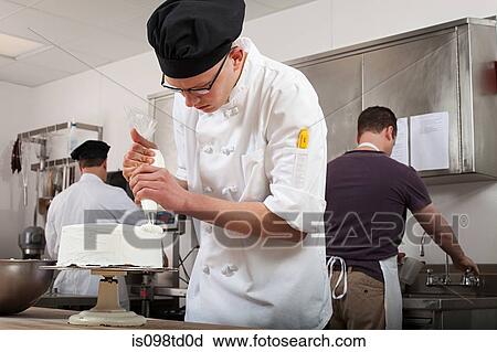 Stock Image - Making cake in commercial kitchen. Fotosearch