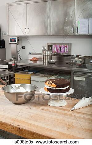 Stock Photo - Making cake in commercial kitchen. Fotosearch