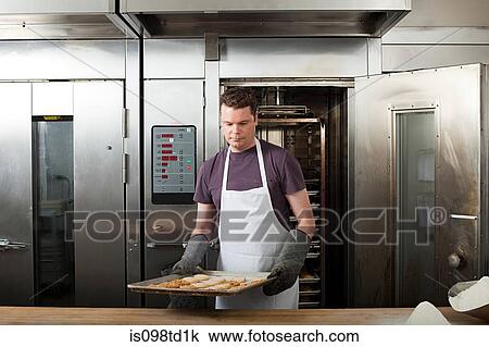 Male chef baking cookies in commercial kitchen View Large Photo Image Stock Image - Male chef baking cookies in commercial kitchen. Fotosearch
