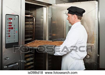 Male chef baking cookies in commercial kitchen View Large Photo Image Stock Photo - Male chef baking cookies in commercial kitchen. Fotosearch