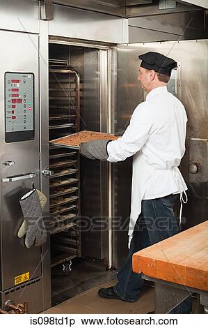 Male chef baking cookies in commercial kitchen View Large Photo Image Stock Photography - Male chef baking cookies in commercial kitchen. Fotosearch
