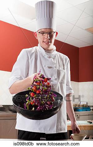 Male chef frying with wok in commercial kitchen View Large Photo Image Stock Image - Male chef frying with wok in commercial kitchen. Fotosearch