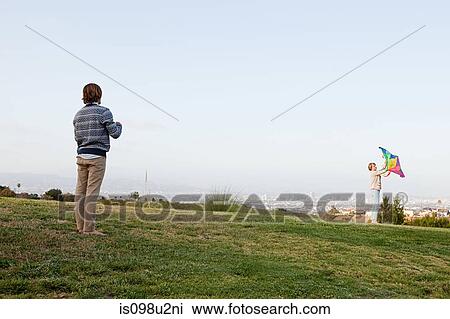 Young couple in field with kite View Large Photo Image Stock Image - Young couple in field with kite. Fotosearch