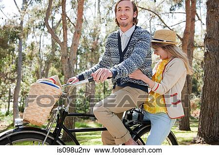 Young couple on a bicycle View Large Photo Image Stock Photo - Young couple on a bicycle. Fotosearch
