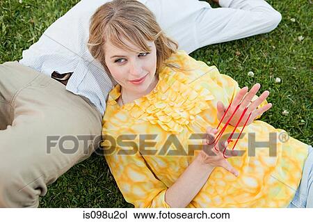 Young couple outdoors, woman playing with string View Large Photo Image Stock Image - Young couple outdoors, woman playing with string. Fotosearch