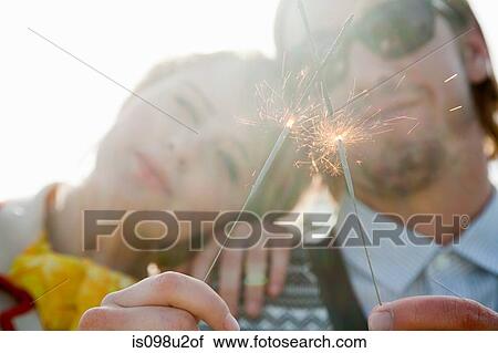 Young couple with sparklers View Large Photo Image Stock Image - Young couple with sparklers. Fotosearch