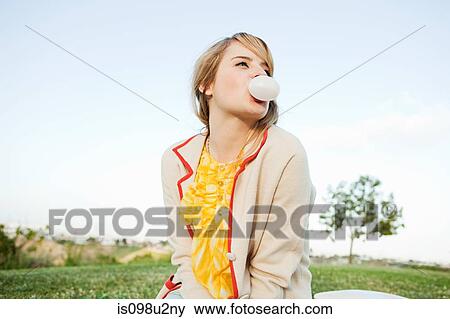 Young woman blowing bubble gum View Large Photo Image Stock Photo - Young woman blowing bubble gum. Fotosearch