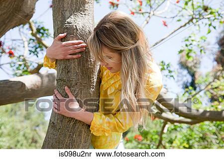 Young woman in a tree View Large Photo Image Stock Photography - Young woman in a tree. Fotosearch