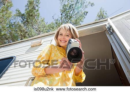 Young woman with a video camera View Large Photo Image Stock Image - Young woman with a video camera. Fotosearch