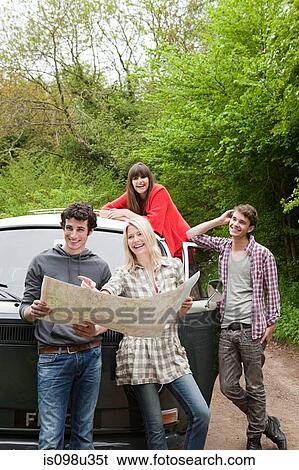 Friends by camper van with map View Large Photo Image Stock Photograph - Friends by camper van with map. Fotosearch
