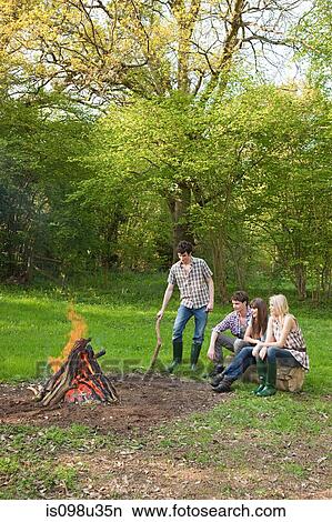 Friends by campfire View Large Photo Image Picture - Friends by campfire. Fotosearch