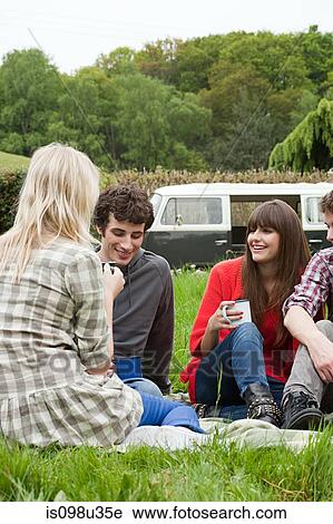 Friends in field by camper van View Large Photo Image Stock Image - Friends in field by camper van. Fotosearch