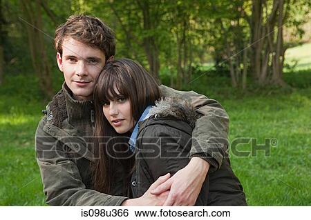 Stock Photograph - Young couple in coats hugging. Fotosearch