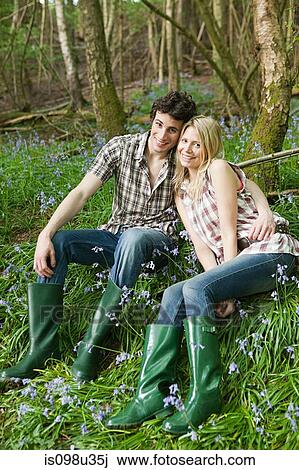 Young couple sitting amongst bluebells View Large Photo Image Stock Image - Young couple sitting amongst bluebells. Fotosearch