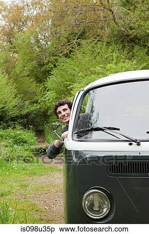 Young man in camper van View Large Photo Image Stock Photography - Young man in camper van. Fotosearch