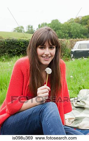 Stock Photo - Young woman with dandelion clock. Fotosearch